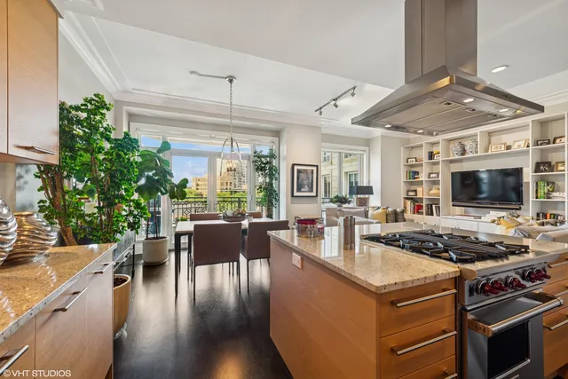 a kitchen with a table chairs stove and cabinets