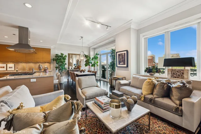 a living room with furniture wooden floor and a view of kitchen