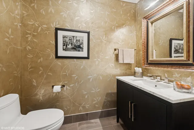 a bathroom with a toilet sink and mirror