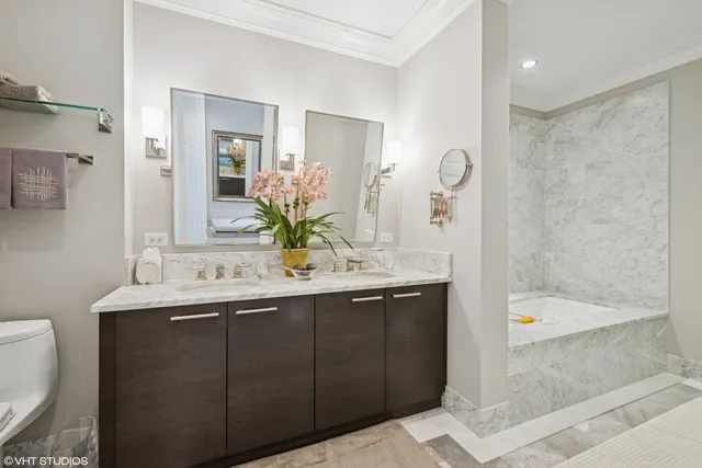 a bathroom with a granite countertop sink a toilet and shower