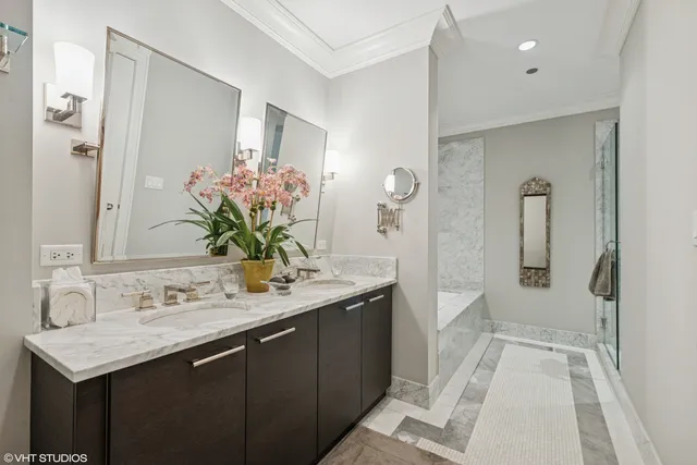 a bathroom with a sink double vanity and shower