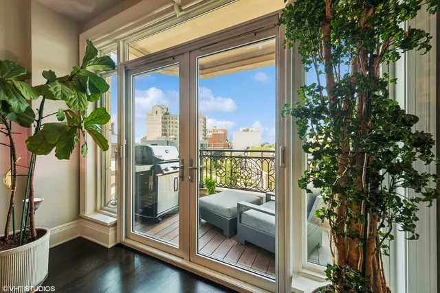 a balcony with furniture and a potted plant