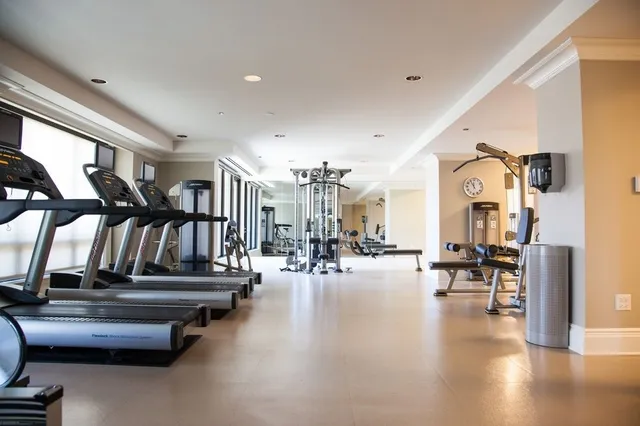 a gym room with lots of gym equipment