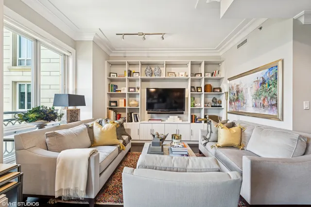 a living room with furniture large window and flat screen tv