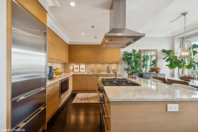 a kitchen with stainless steel appliances granite countertop a sink and a refrigerator