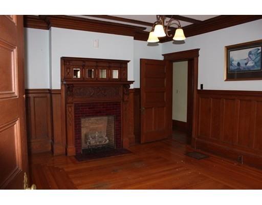 20 Marble Street Worcester, MA 01603 - Photo 22 of 30 a view of an empty room with wooden floor fireplace and a window