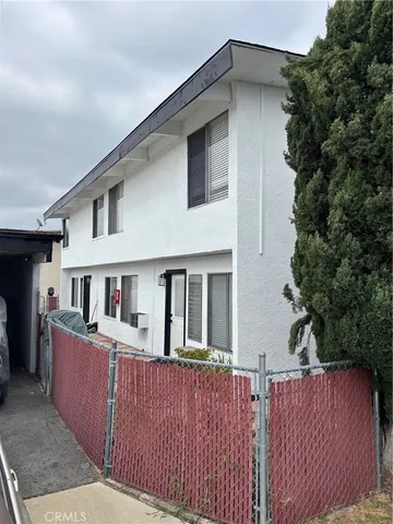 a view of a house with wooden deck and a yard