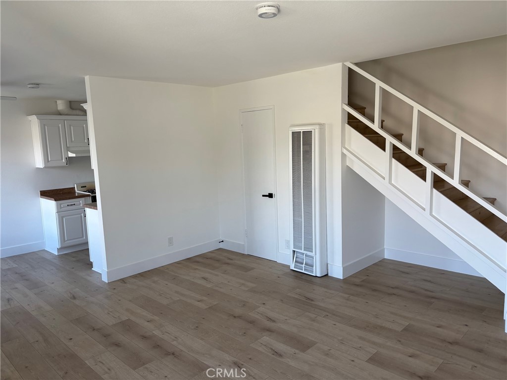 7160 Cerritos Avenue Stanton, CA 90680 - Photo 7 of 10 a view of an empty room with wooden floor