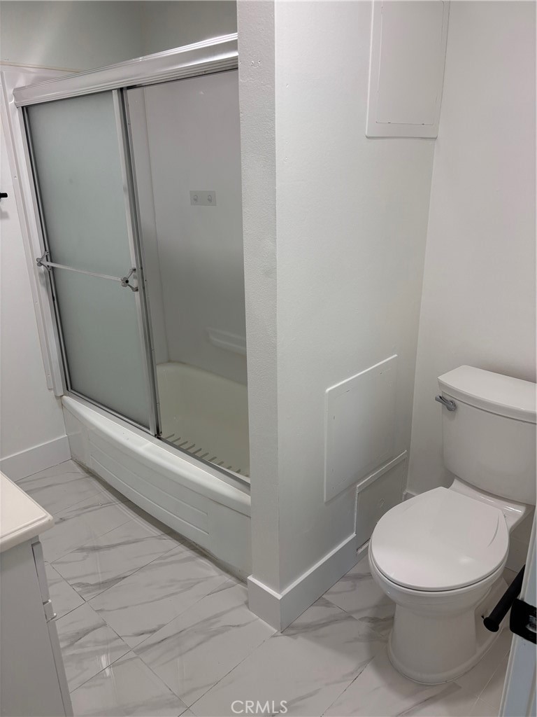 7160 Cerritos Avenue Stanton, CA 90680 - Photo 8 of 10 a white toilet sitting next to a shower