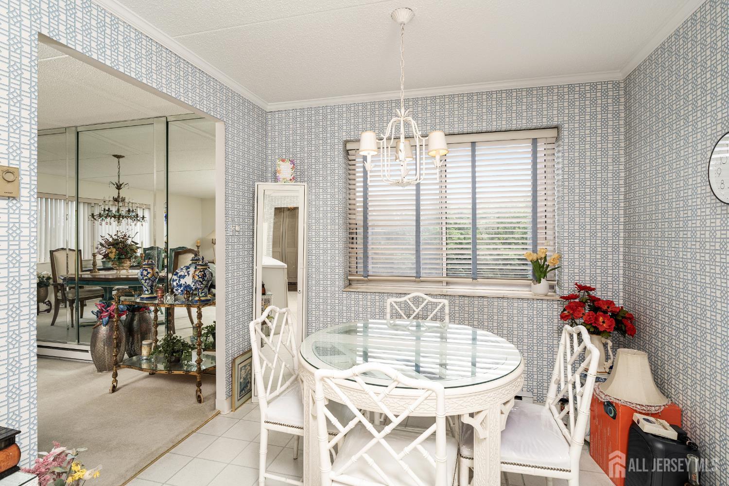 860 Lower Ferry Road, Unit 6D Ewing, NJ 08628 - Photo 19 of 40 a view of a dining room with furniture and chandelier