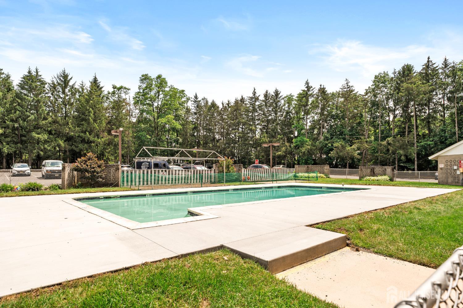 860 Lower Ferry Road, Unit 6D Ewing, NJ 08628 - Photo 40 of 40 a view of swimming pool with yard and trees in the background