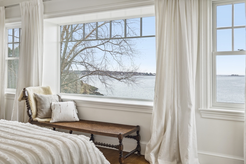24 Greystone Road Marblehead, MA 01945 - Photo 27 of 42 a bedroom with a bed and a window with a chair