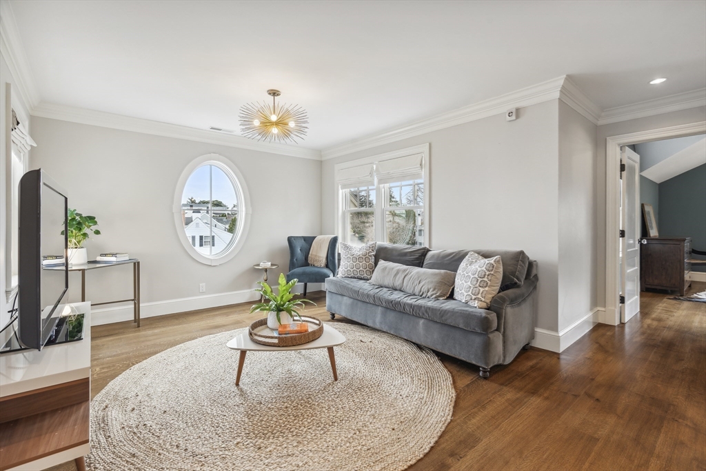 24 Greystone Road Marblehead, MA 01945 - Photo 31 of 42 a living room with furniture a clock and a flat screen tv
