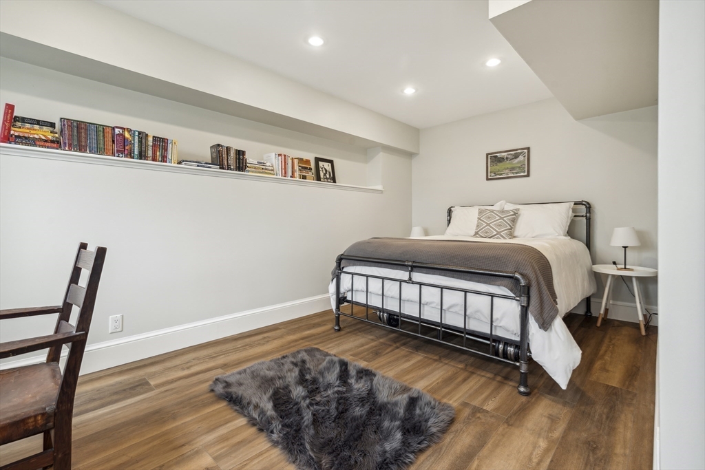 24 Greystone Road Marblehead, MA 01945 - Photo 38 of 42 a bedroom with a bed and a bookshelf