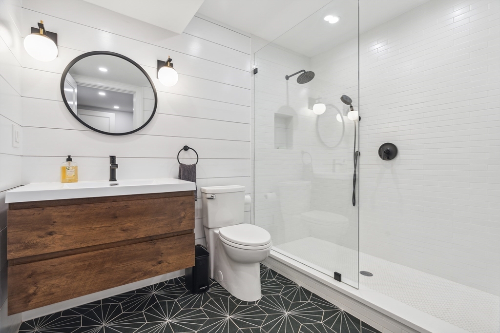 24 Greystone Road Marblehead, MA 01945 - Photo 39 of 42 a bathroom with a sink a toilet and a mirror