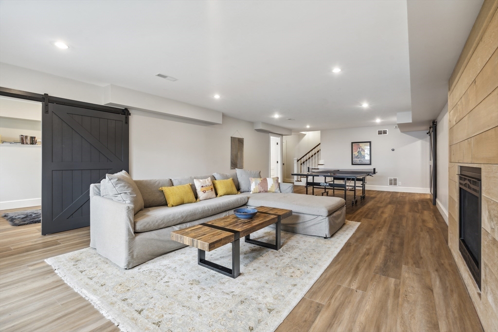 24 Greystone Road Marblehead, MA 01945 - Photo 40 of 42 a living room with furniture and a wooden floor