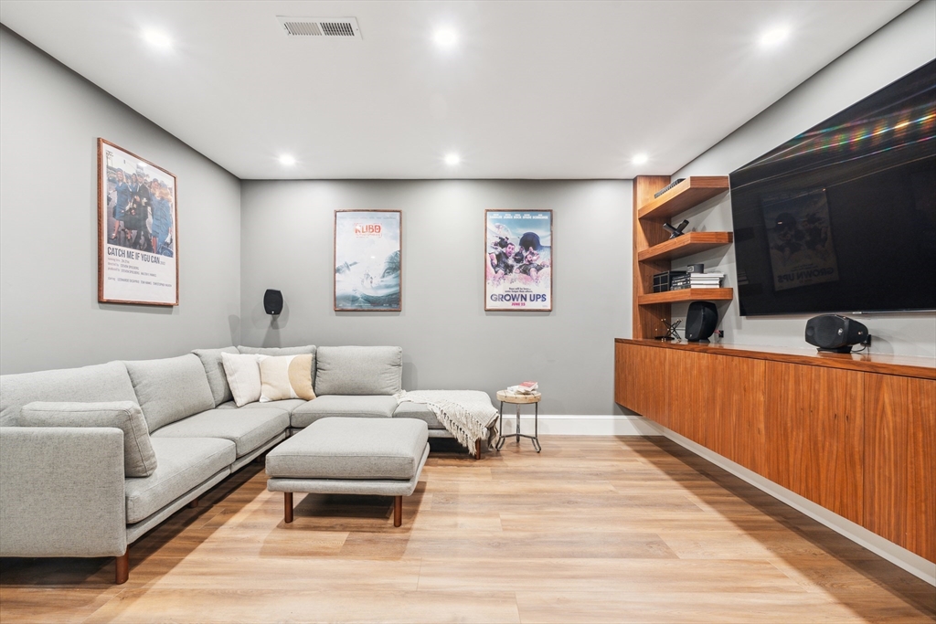 24 Greystone Road Marblehead, MA 01945 - Photo 41 of 42 a living room with furniture a flat screen tv and kitchen view