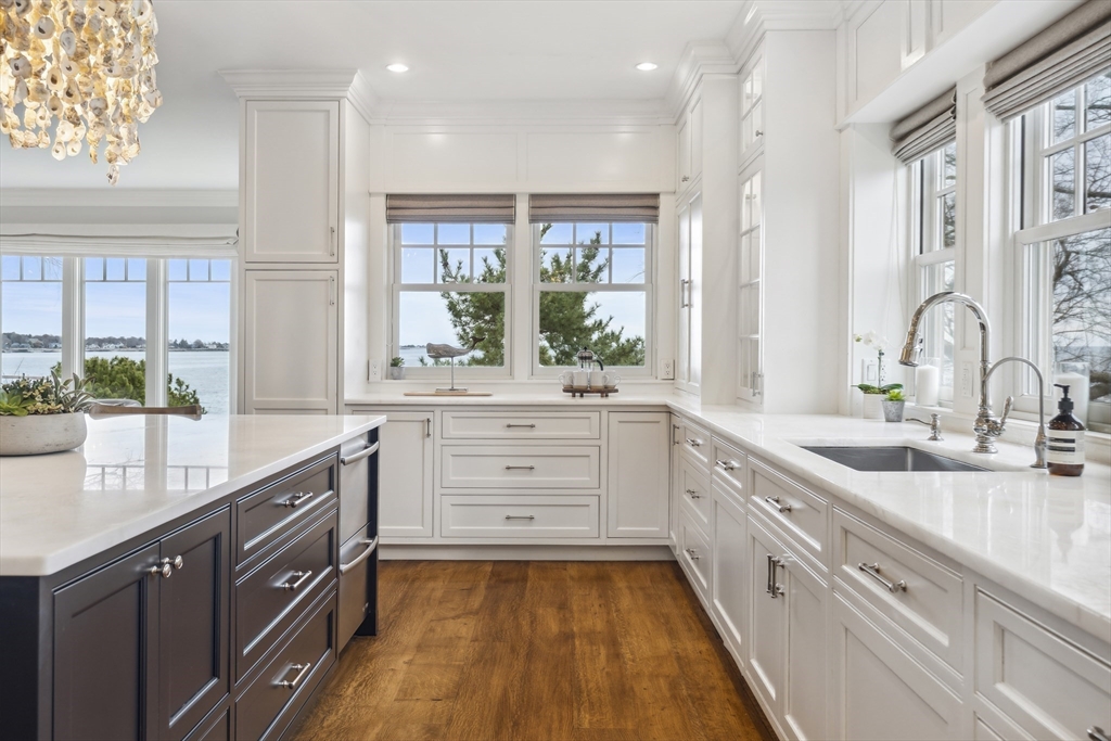24 Greystone Road Marblehead, MA 01945 - Photo 9 of 42 a large kitchen with kitchen island white cabinets and stainless steel appliances