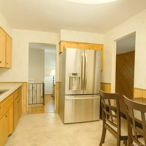 a kitchen with stainless steel appliances granite countertop a refrigerator and a stove