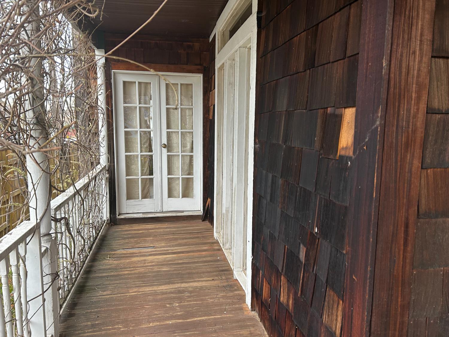 115 South Ione Street Ione, CA 95640 - Photo 14 of 15 a view of a porch with wooden floor and stairs