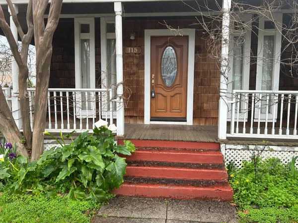 a front view of a house with a garden
