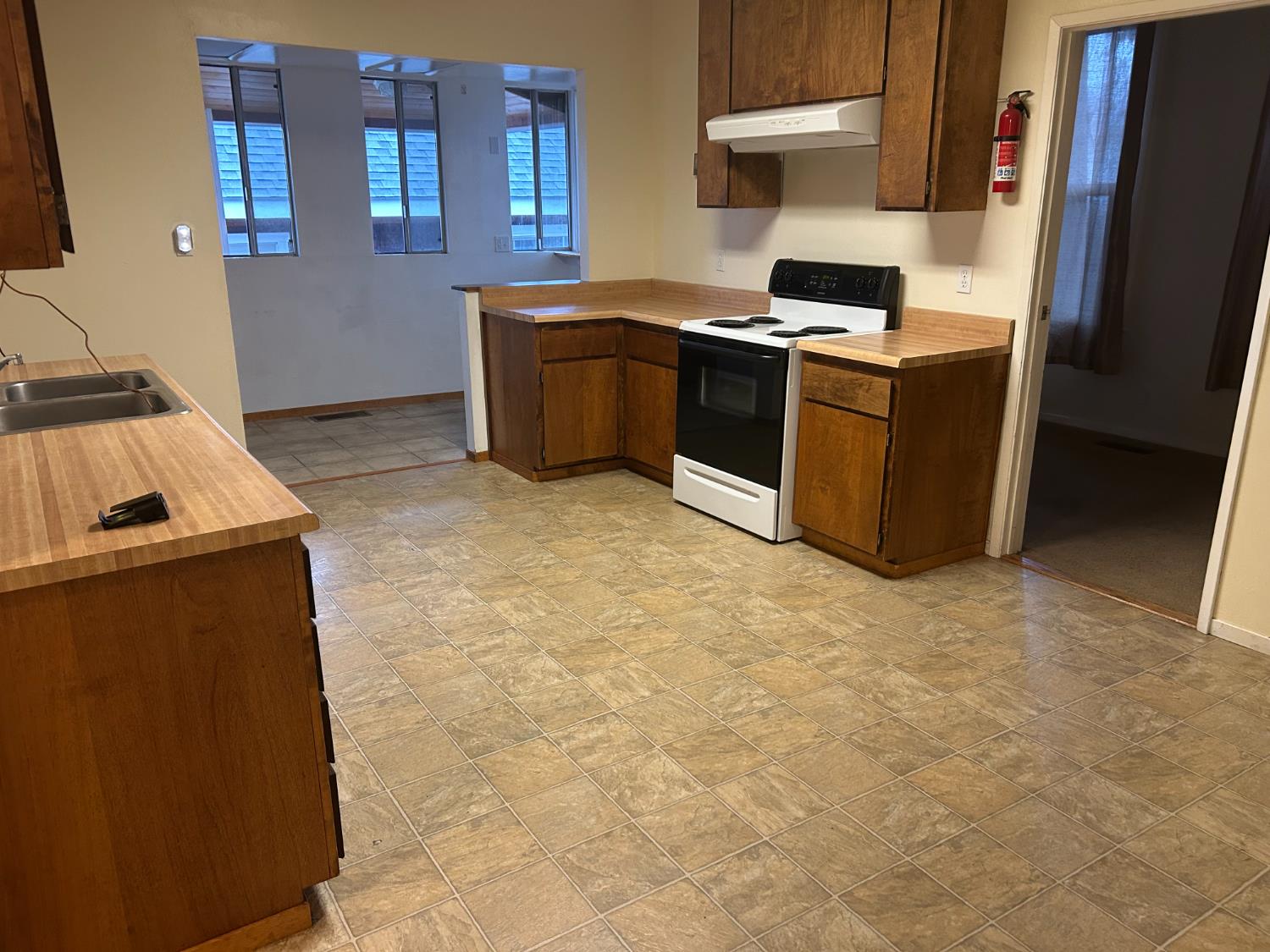 115 South Ione Street Ione, CA 95640 - Photo 5 of 15 a kitchen with stainless steel appliances granite countertop a sink stove and refrigerator