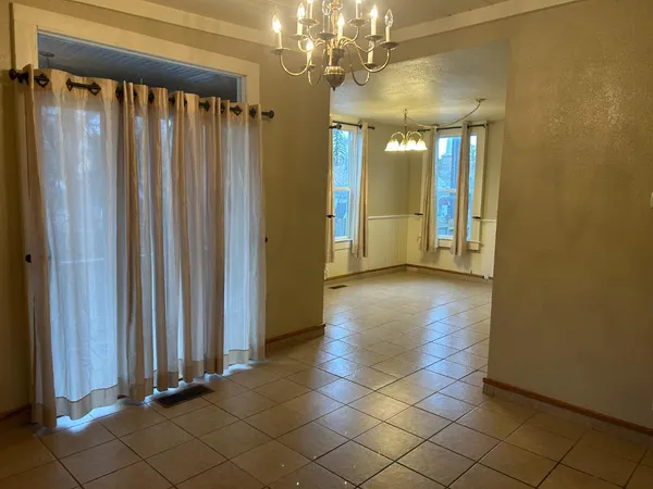 a view of a hallway with chandelier