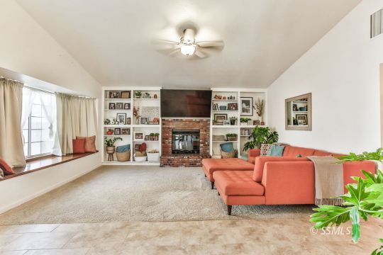 205 North Broadway Street Ridgecrest, CA 93555 - Photo 11 of 29 a living room with furniture a fireplace and a flat screen tv