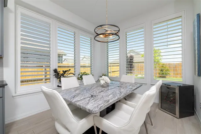 a living room with furniture a flat screen tv and a chandelier