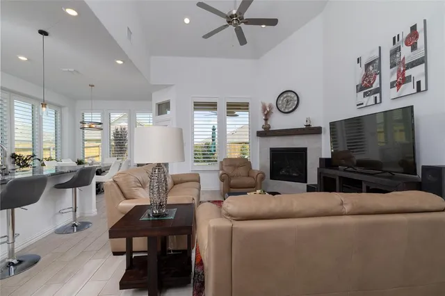 a living room with fireplace furniture and a flat screen tv