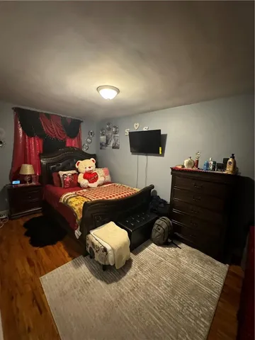 a bedroom with furniture and a mirror