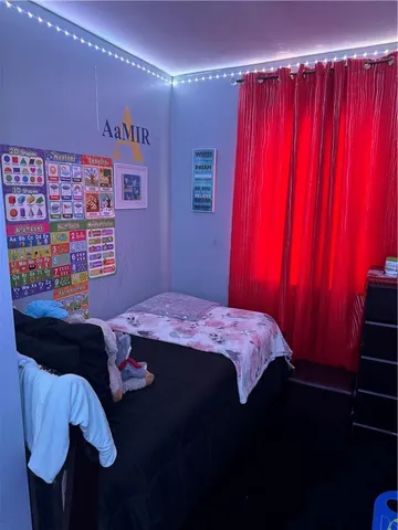 a bed sitting in a bedroom next to a window