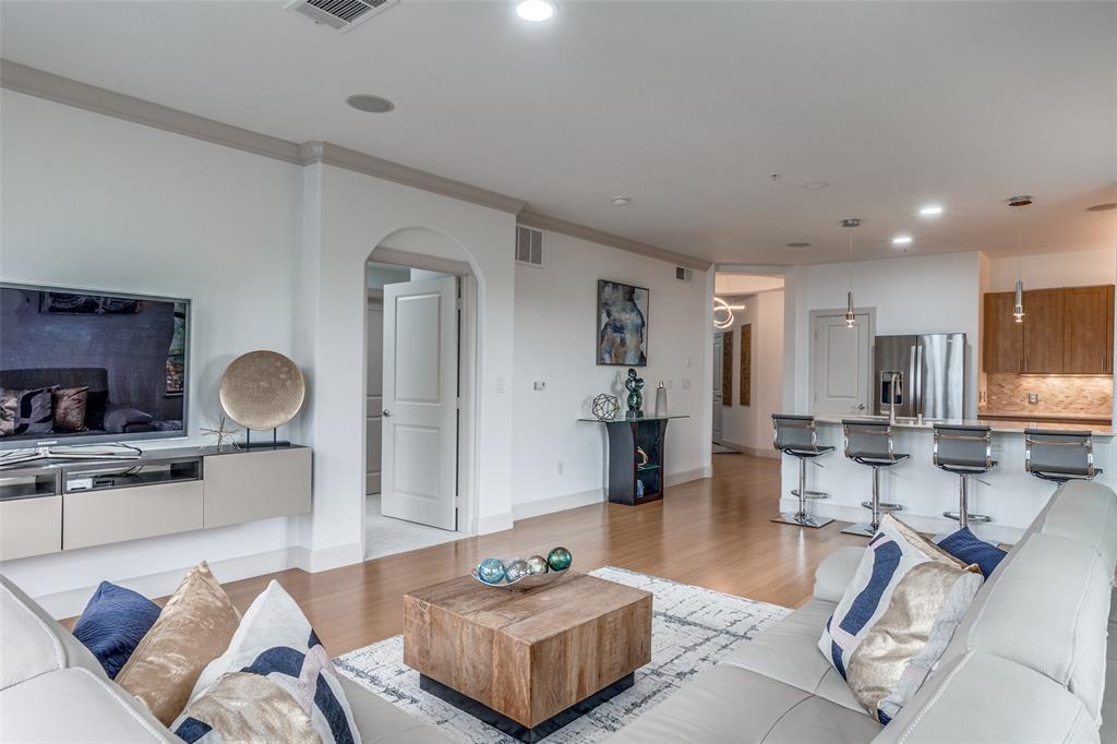 3818 Holland Avenue, Unit 309 Dallas, TX 75219 - Photo 11 of 24 a living room with furniture and a wooden floor