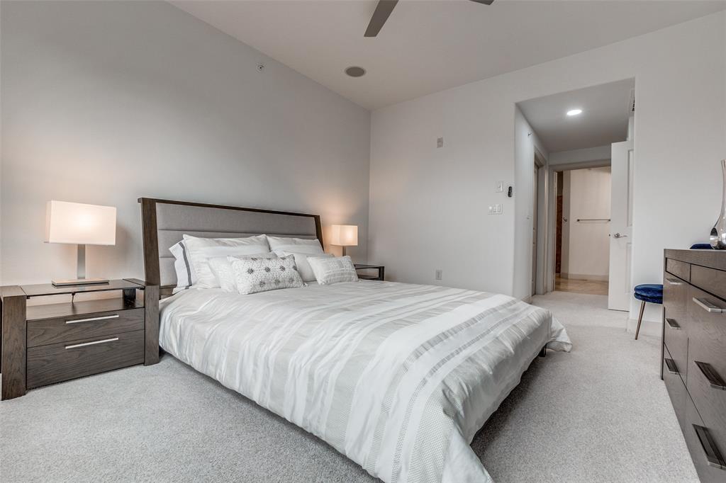 3818 Holland Avenue, Unit 309 Dallas, TX 75219 - Photo 13 of 24 a bedroom with a bed and a lamp