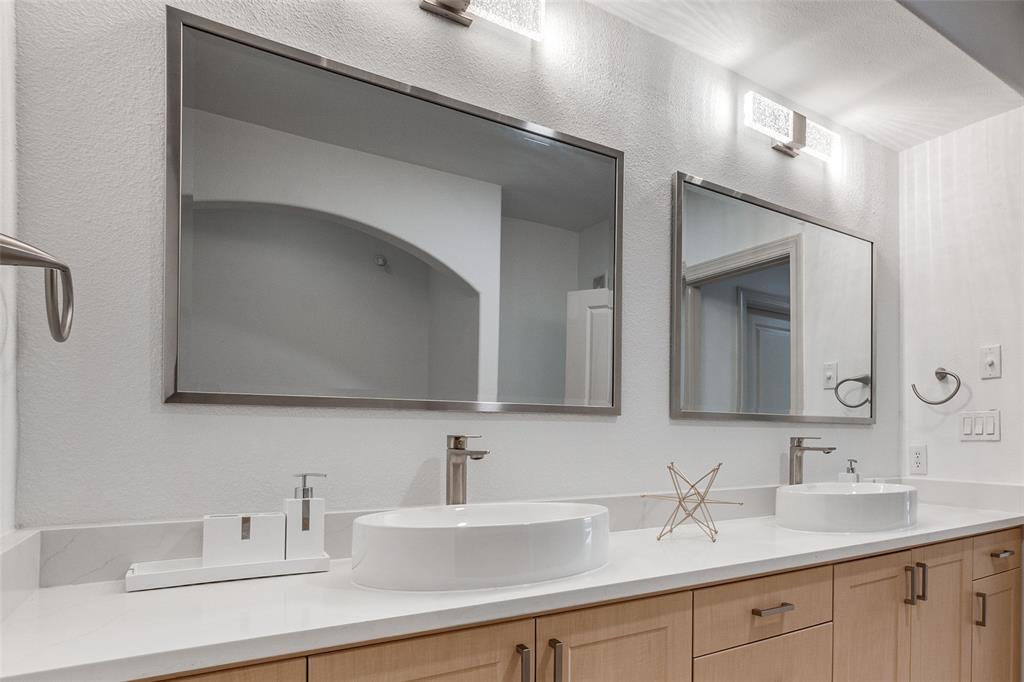 3818 Holland Avenue, Unit 309 Dallas, TX 75219 - Photo 16 of 24 a bathroom with 2 sink and a mirror