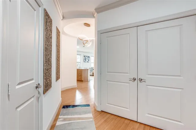 a view of a hallway with wooden floor and staircase
