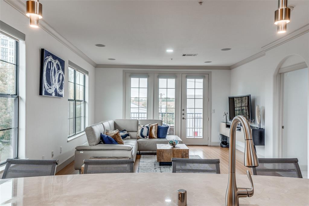 3818 Holland Avenue, Unit 309 Dallas, TX 75219 - Photo 7 of 24 a living room with furniture and a large window
