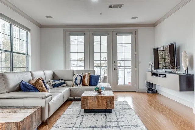 a living room with furniture and wooden floor