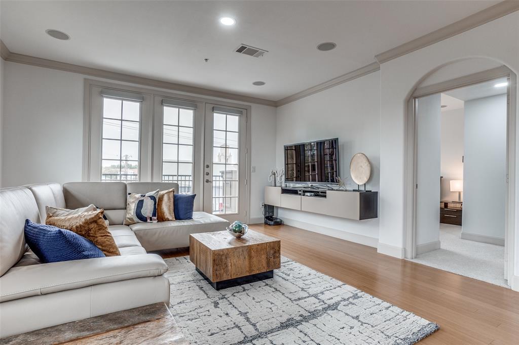 3818 Holland Avenue, Unit 309 Dallas, TX 75219 - Photo 10 of 24 a living room with furniture and wooden floor