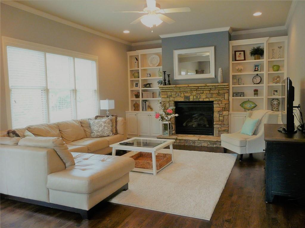 3970 Sweeting Street Cumming, GA 30041 - Photo 8 of 17 a living room with furniture and a fireplace