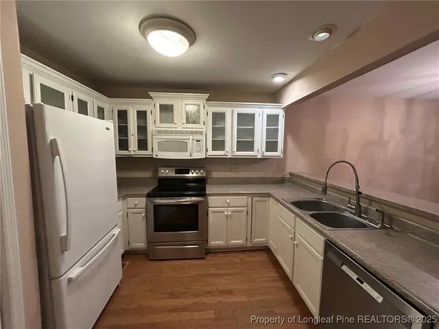 a view of staircase with white walls and a window