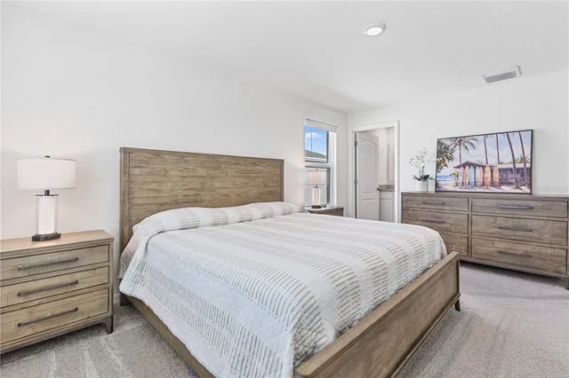 a bathroom with a granite countertop sink toilet and mirror