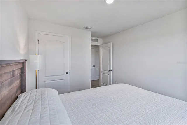a bathroom with a granite countertop sink and a toilet