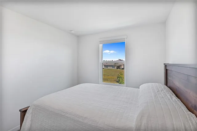a bathroom with a granite countertop toilet sink and mirror