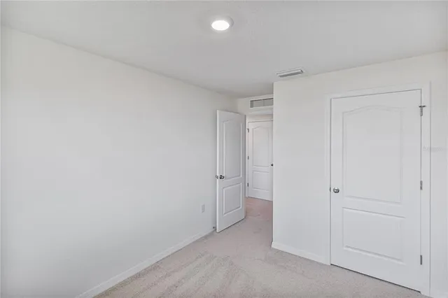 a view of a hallway with closet and entryway