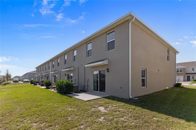 a spacious bathroom with a double vanity sink a mirror and a bathtub