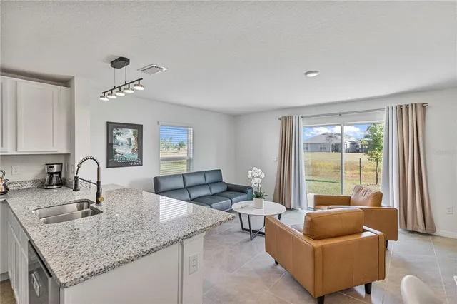 a kitchen with granite countertop a couch and a couch