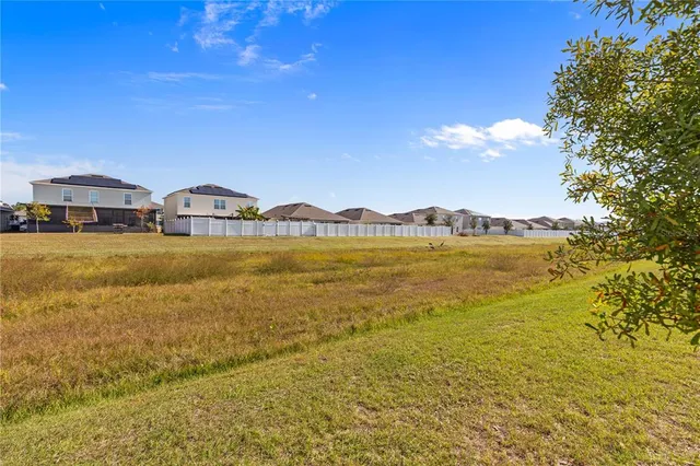 a large kitchen with stainless steel appliances granite countertop a refrigerator and a sink