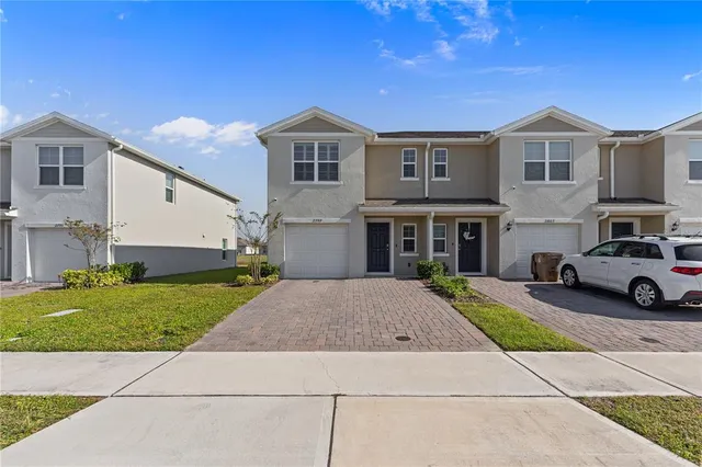 a living room with furniture and floor to ceiling windows