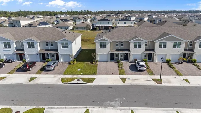 a living room with furniture ceiling fan and a large window